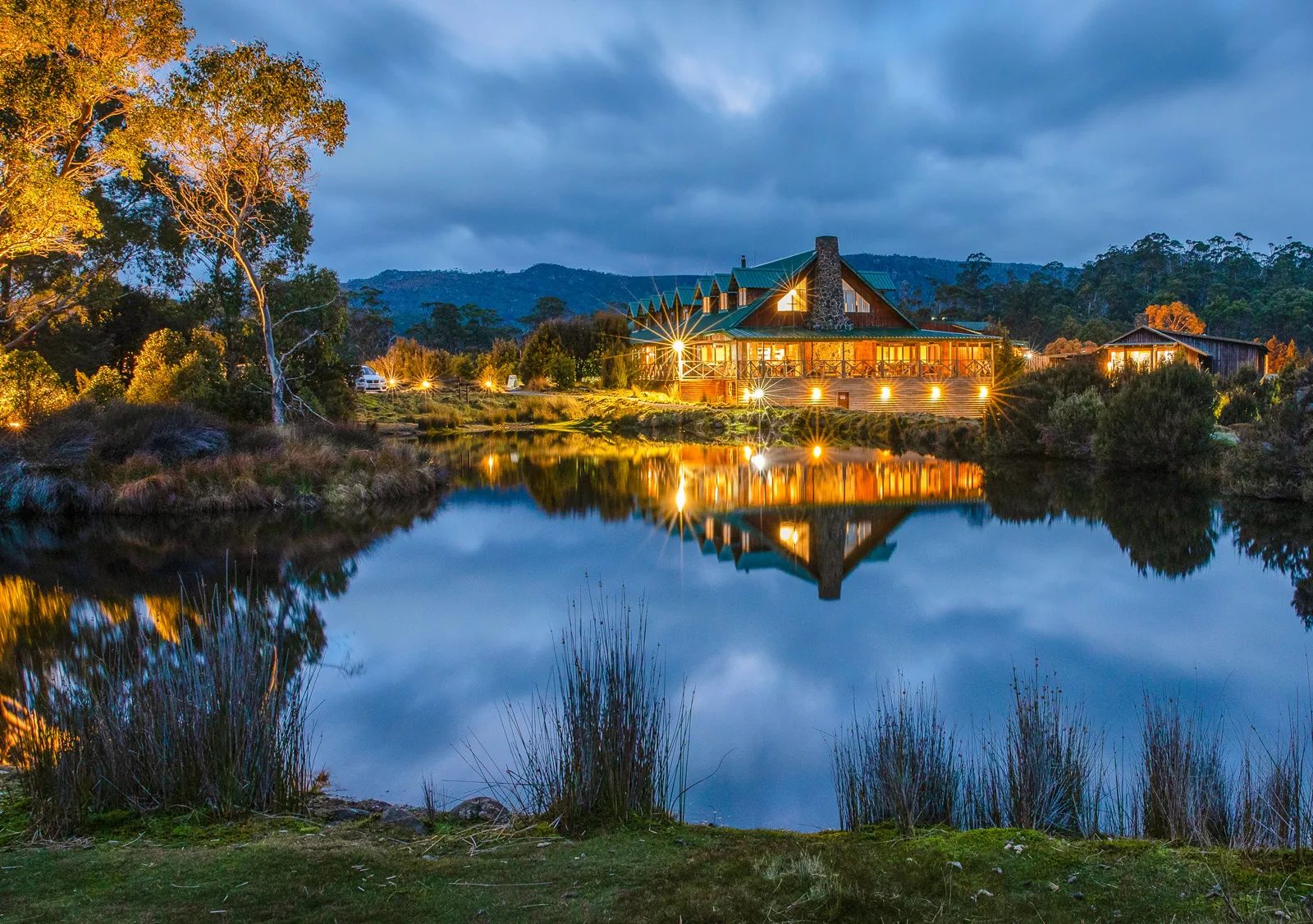 hotel lit up at night across a lake