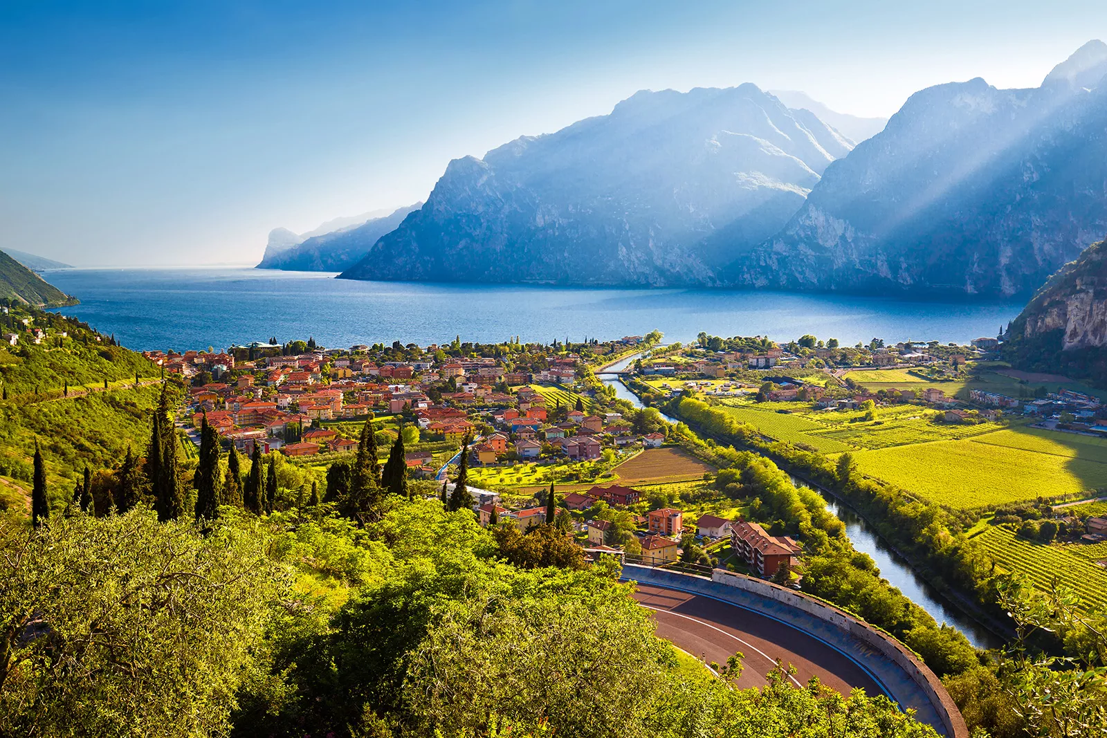 Small oceanside town with crop fields and mountains