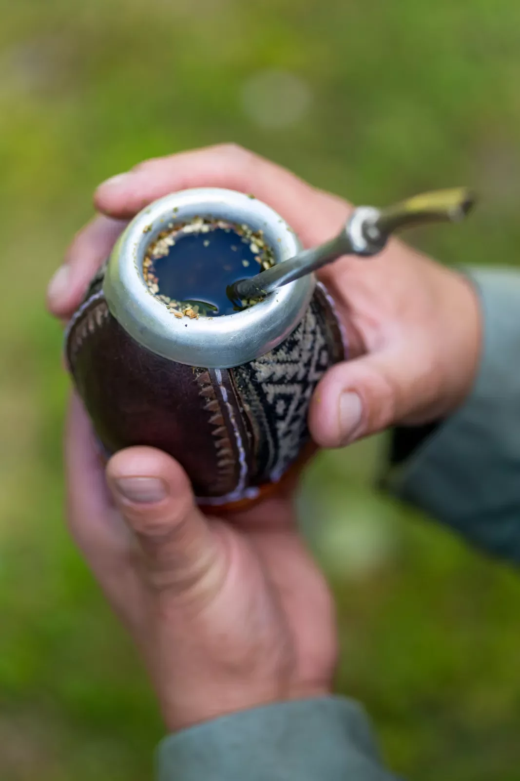 Traditional mate drink, in a small cup with a metal straw sticking out