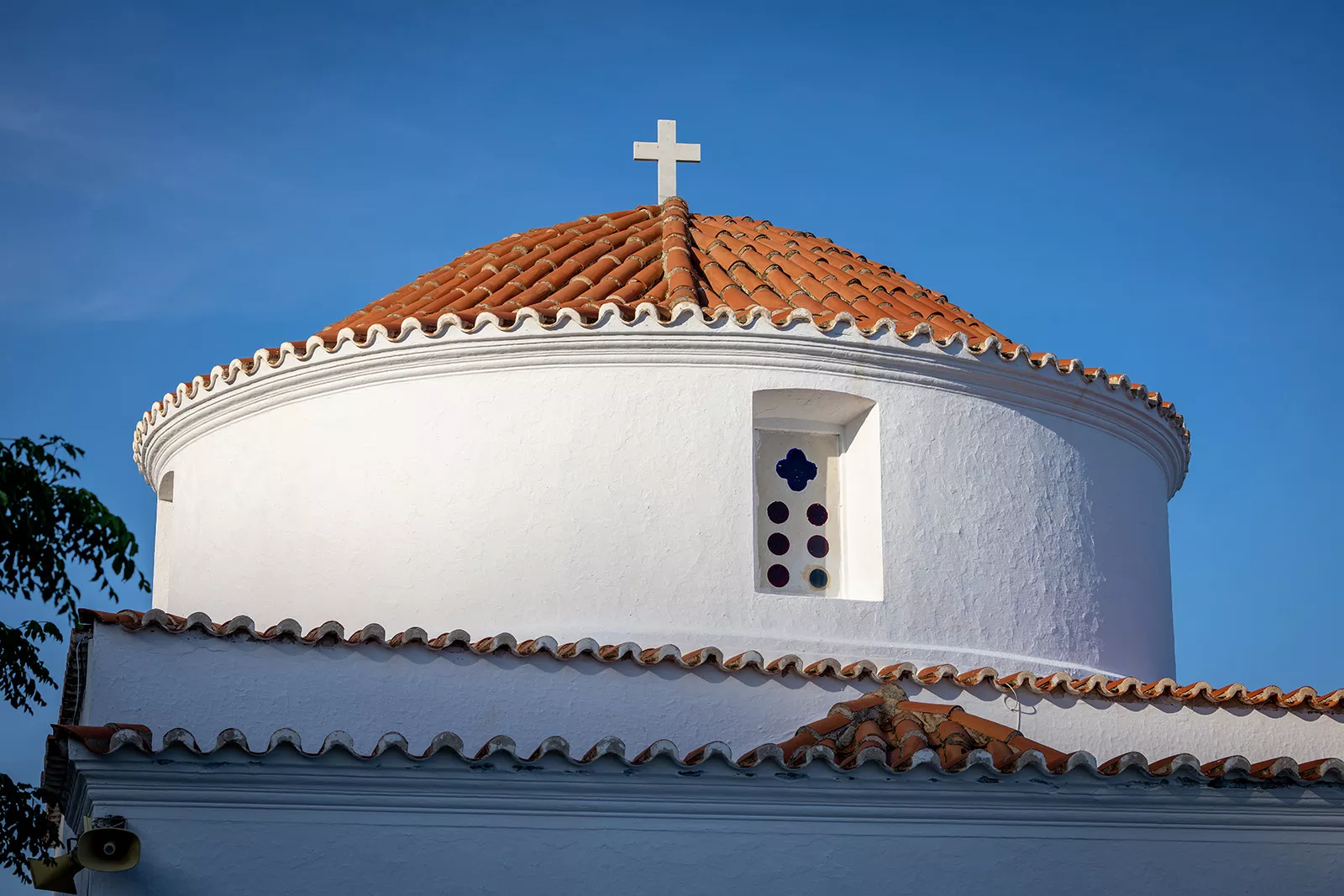 Bottom-top view of a church building with a cross on top