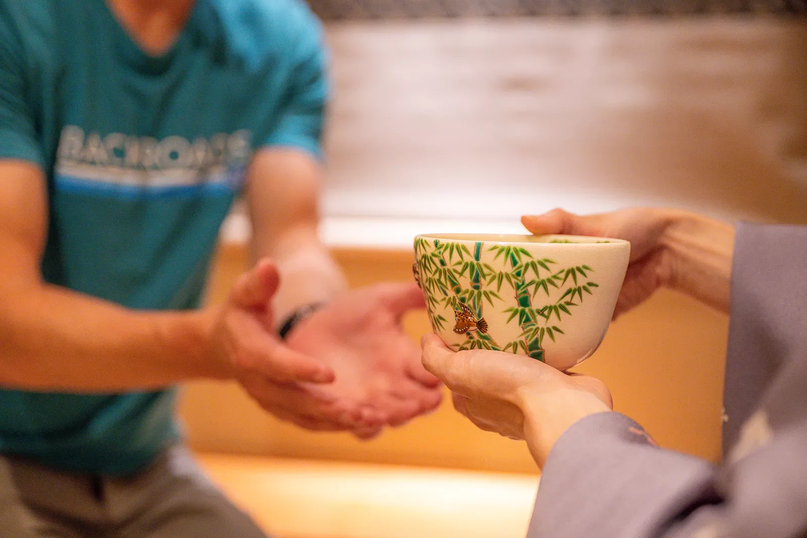 a person hands a bowl to a backroads guest