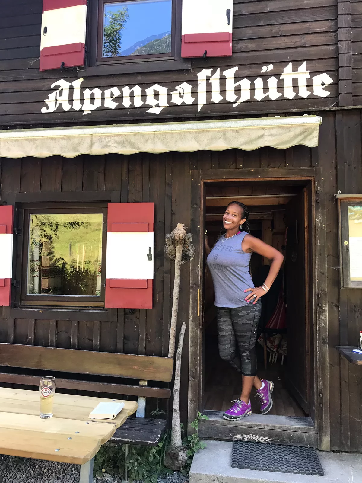 Woman standing in the doorway of a wooden building