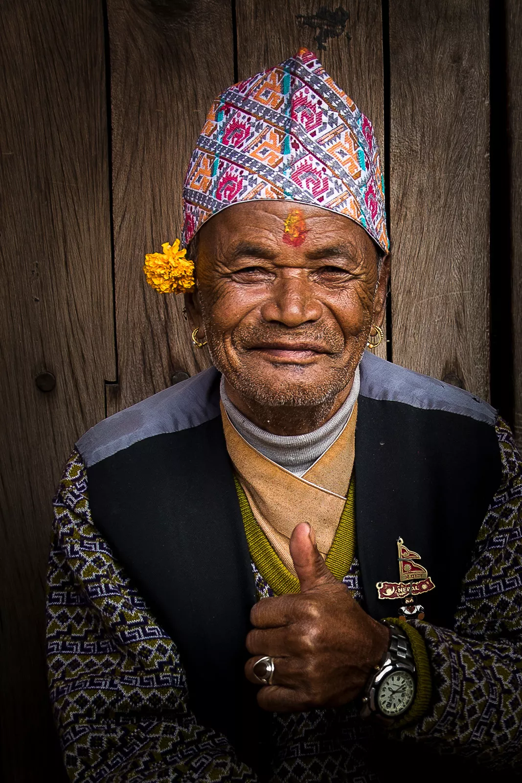 Man with traditional head dress giving a thumbs up