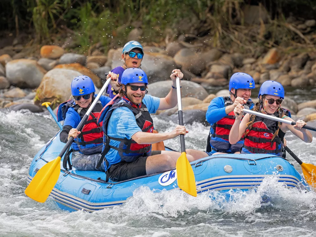 Guests and leader white-water rafting.