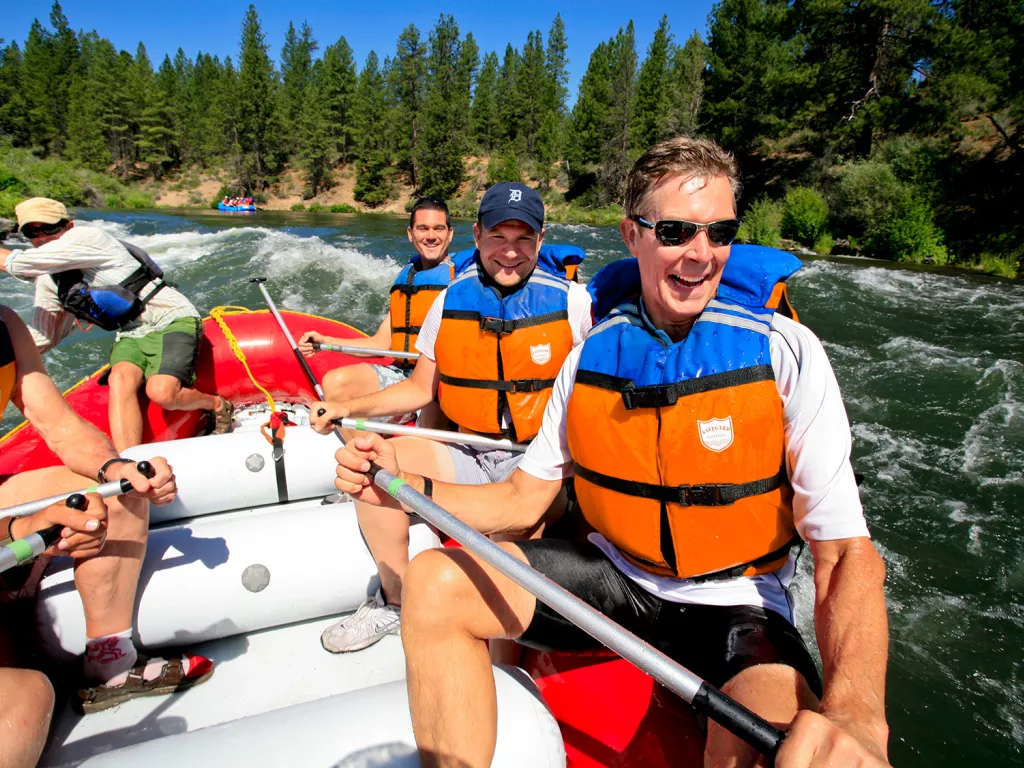 Group of people on a raft while paddling in a river