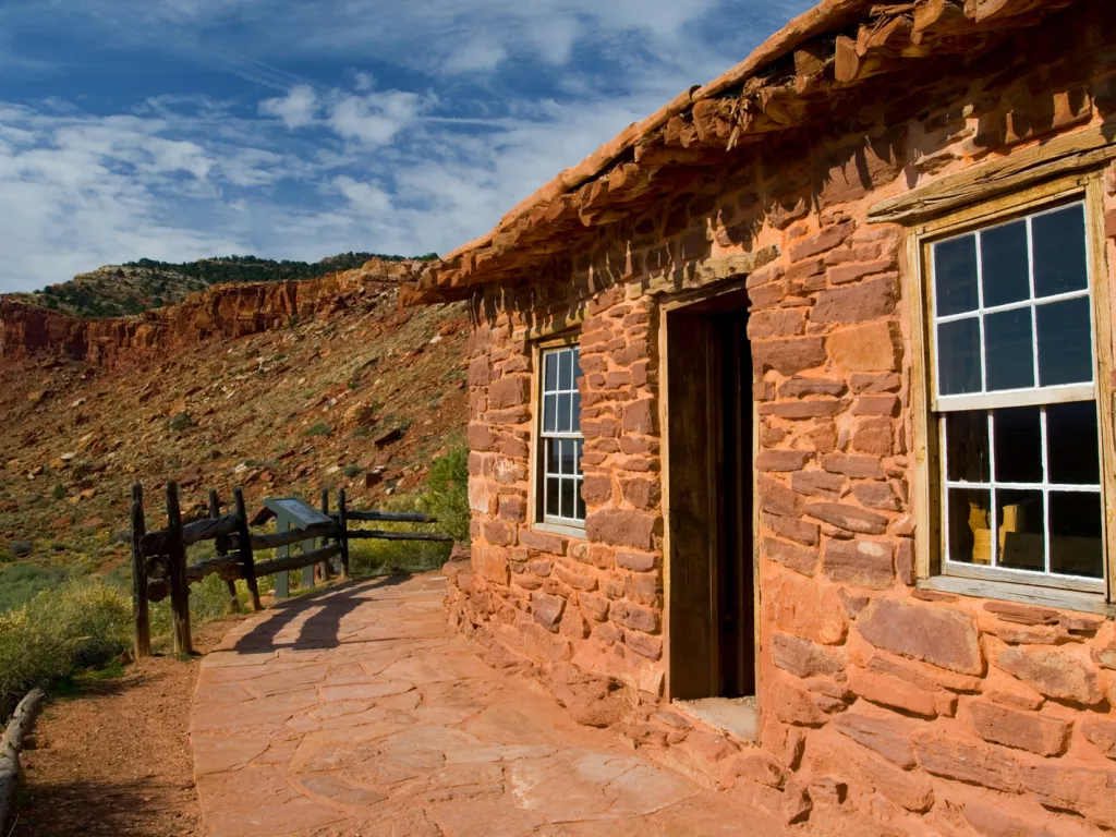 Red brick building in the middle of a rocky valley