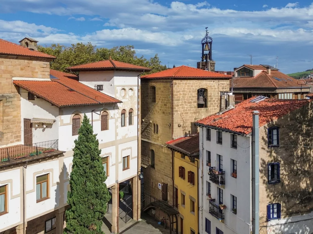 Sky view of 3-story apartment buildings in a small, rustic town