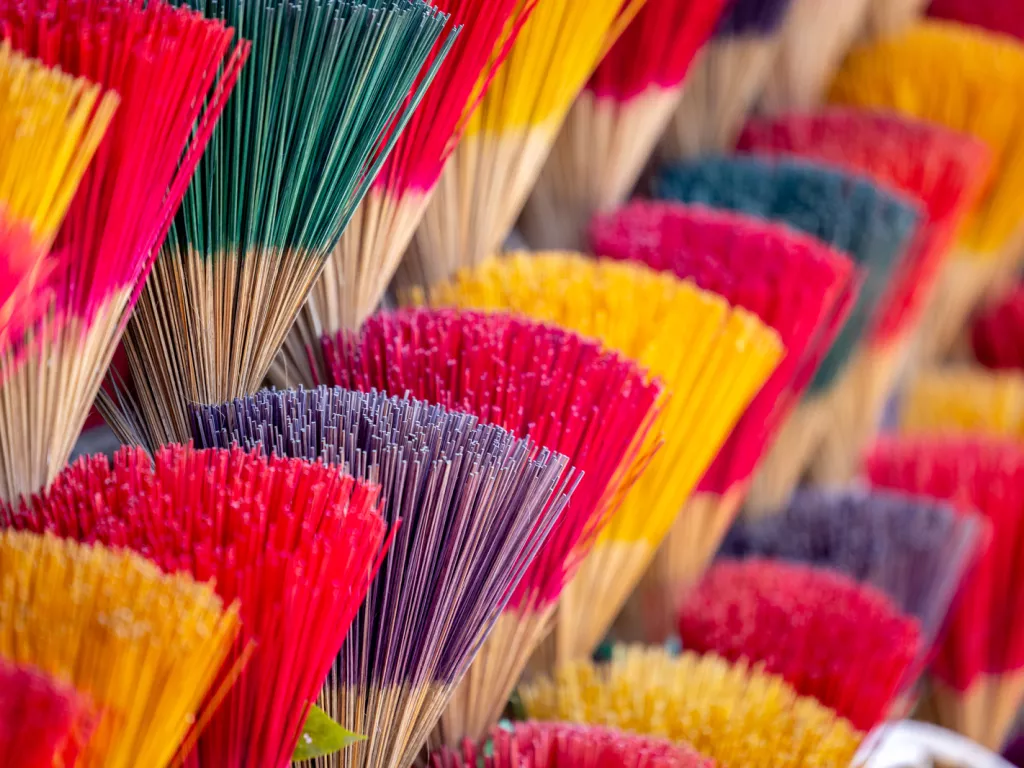 Vendor stall full of colorful incense sticks