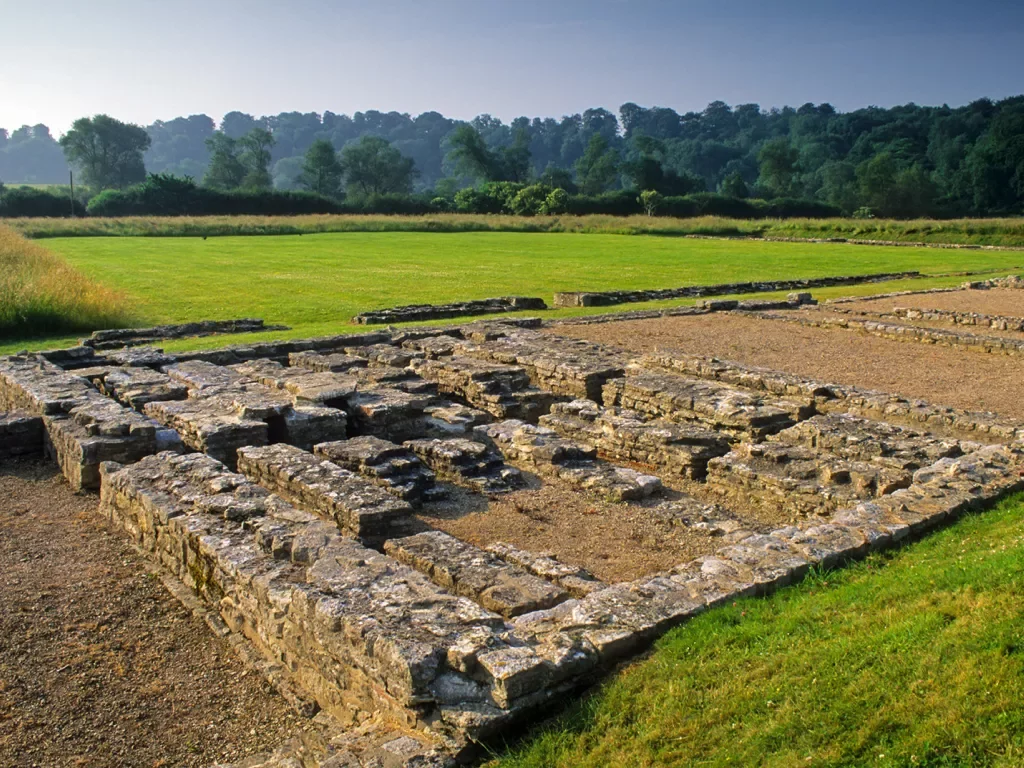 Remains of a brick building next to fields of grass