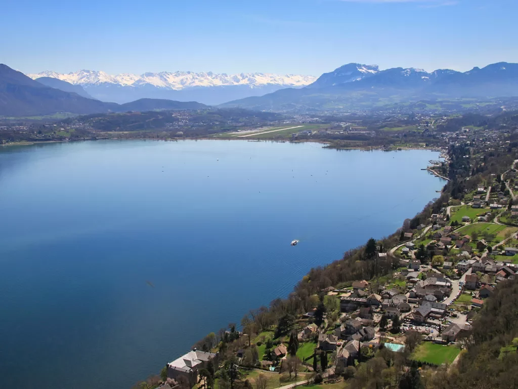 A large lake surrounded by houses and mountains