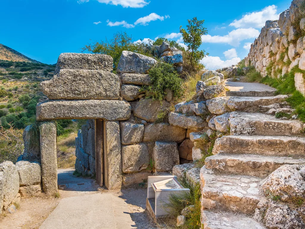 Rustic walkway with stone stairs and archways