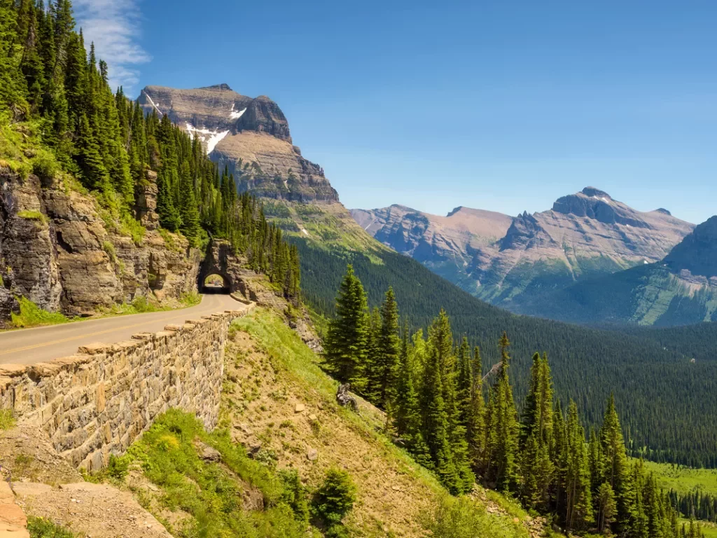 Long road along a cliff with trees in the distance