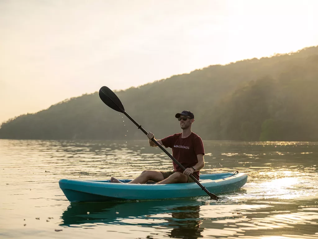 Man on kayak in the middle of a lake