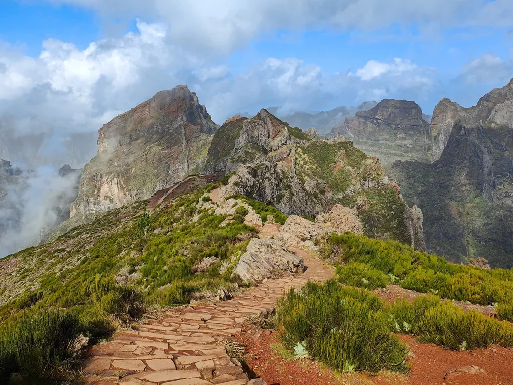 Stone pathway leading towards foggy mountains