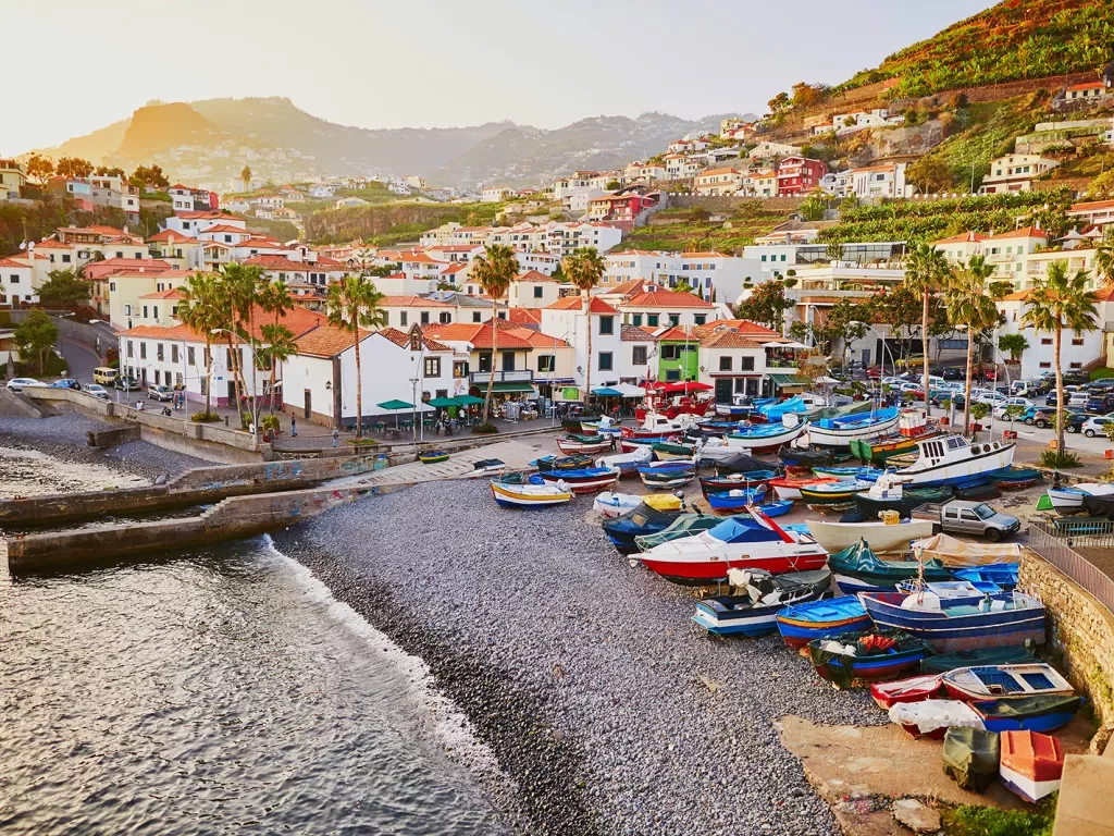 Beachside port full of boats and buildings