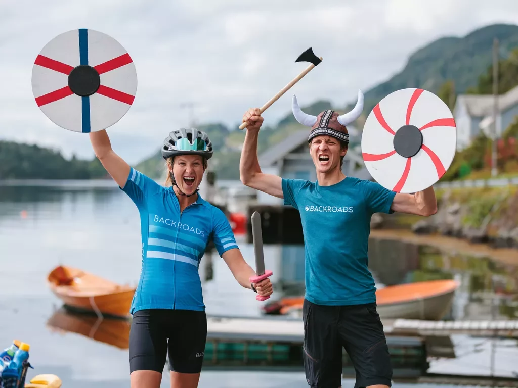 Man and women with plush Viking helmets and weapons