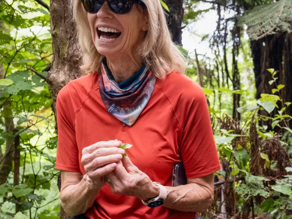 Woman laughing while holding plants in her hand