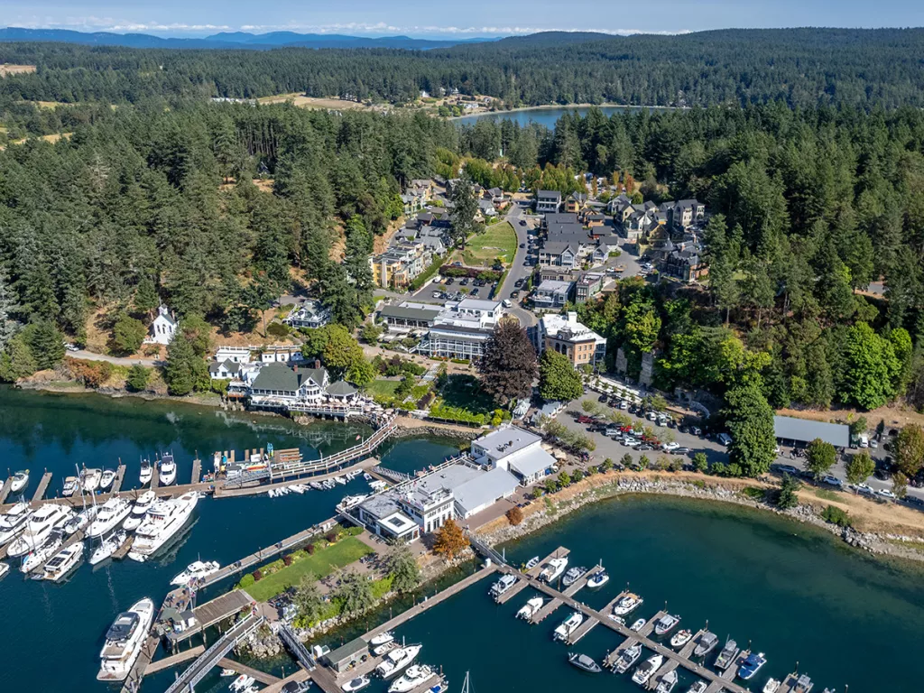 Sky view of a property complex with boats along a port 