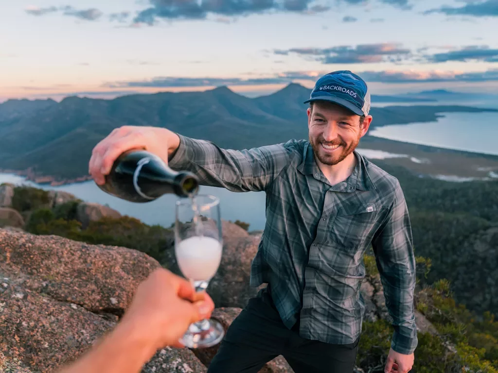 Man pouring alcohol into a small glass