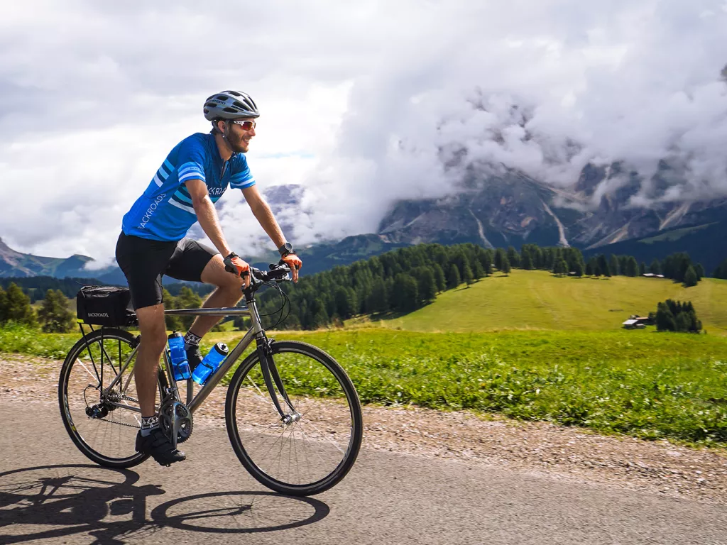 Man wearing sunglasses and riding a bike 