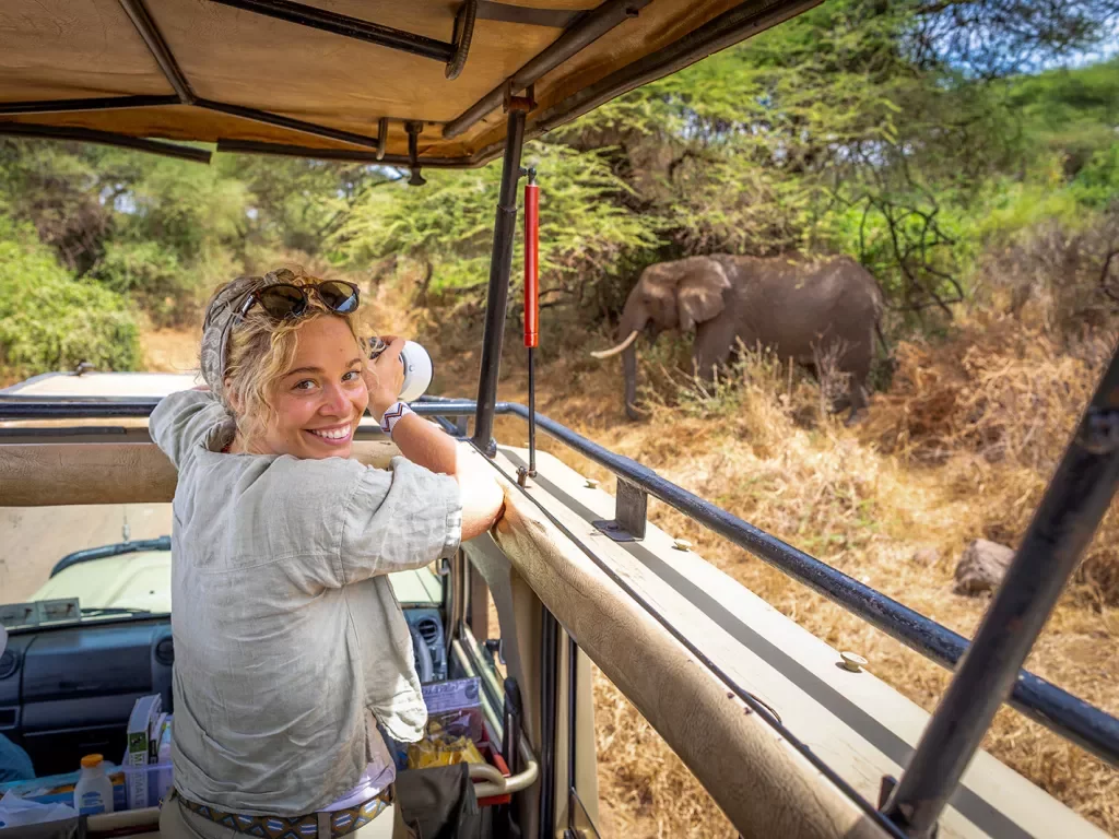 a guest takes a photo on safari
