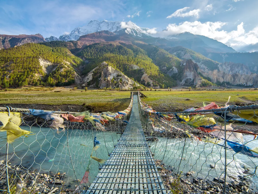 Metal bridge with color flags along the ropes