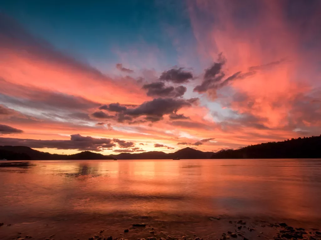 Sunset at the beach with purple and pink clouds