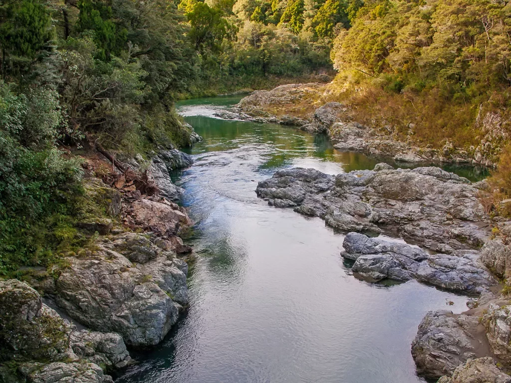 A river cutting through two small cliffs