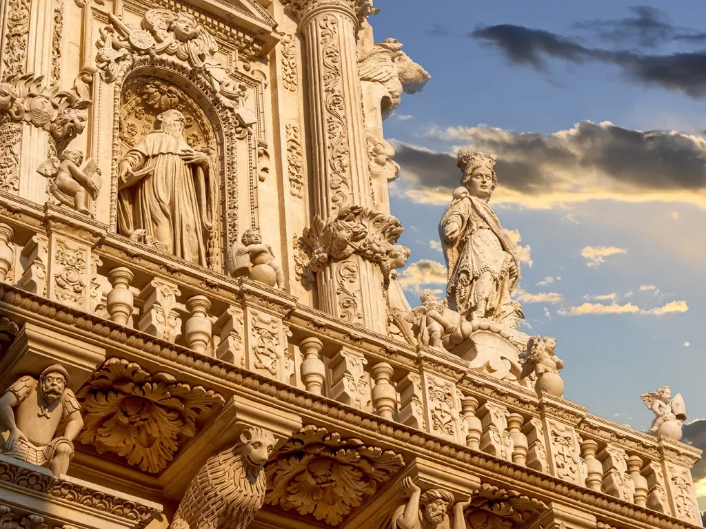 Ancient Roman statue at the top of a building