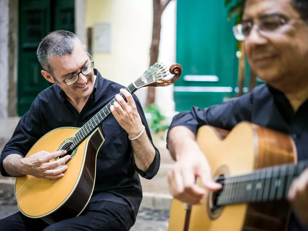 Two men playing guitars