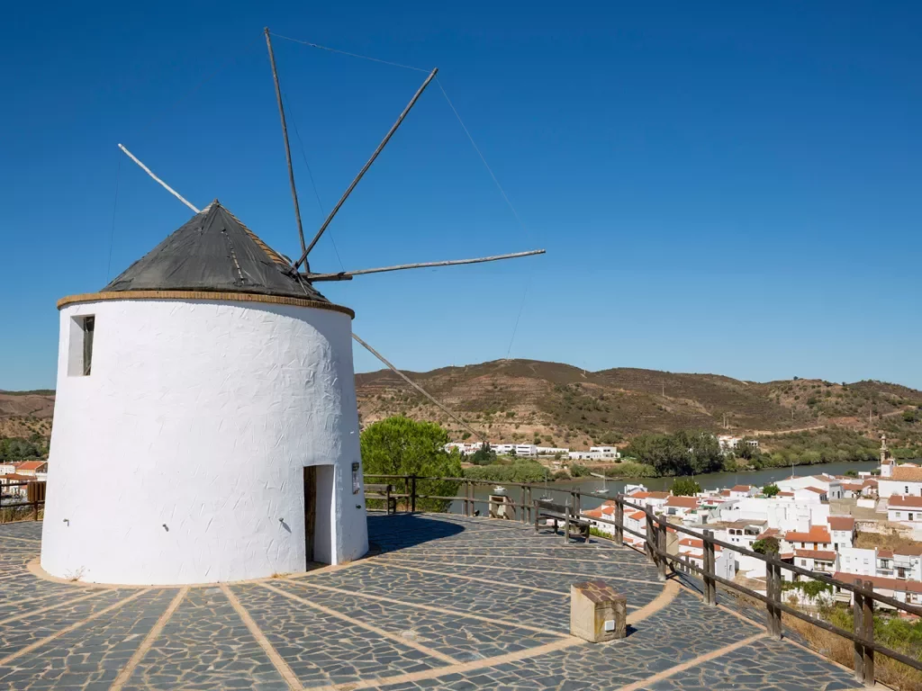 Rustic windmill tower overlooking a small town