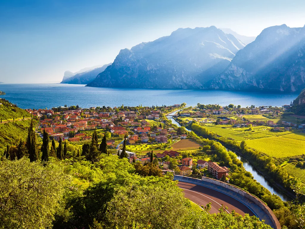 Small oceanside town with crop fields and mountains