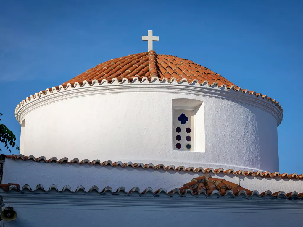 Bottom-top view of a church building with a cross on top