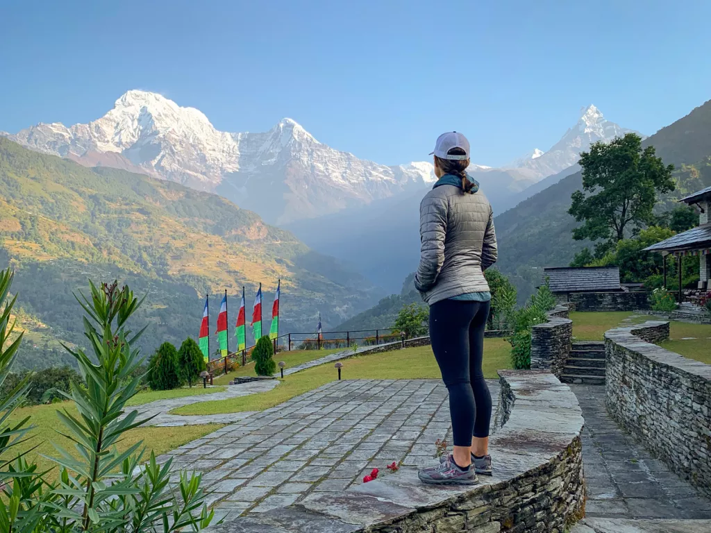 Woman overlooking hills and mountains in the distance