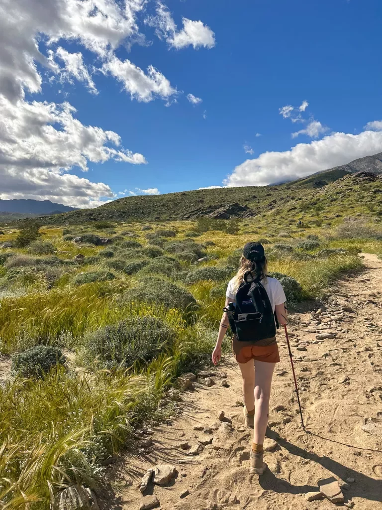 A woman hiking on a dirt path
