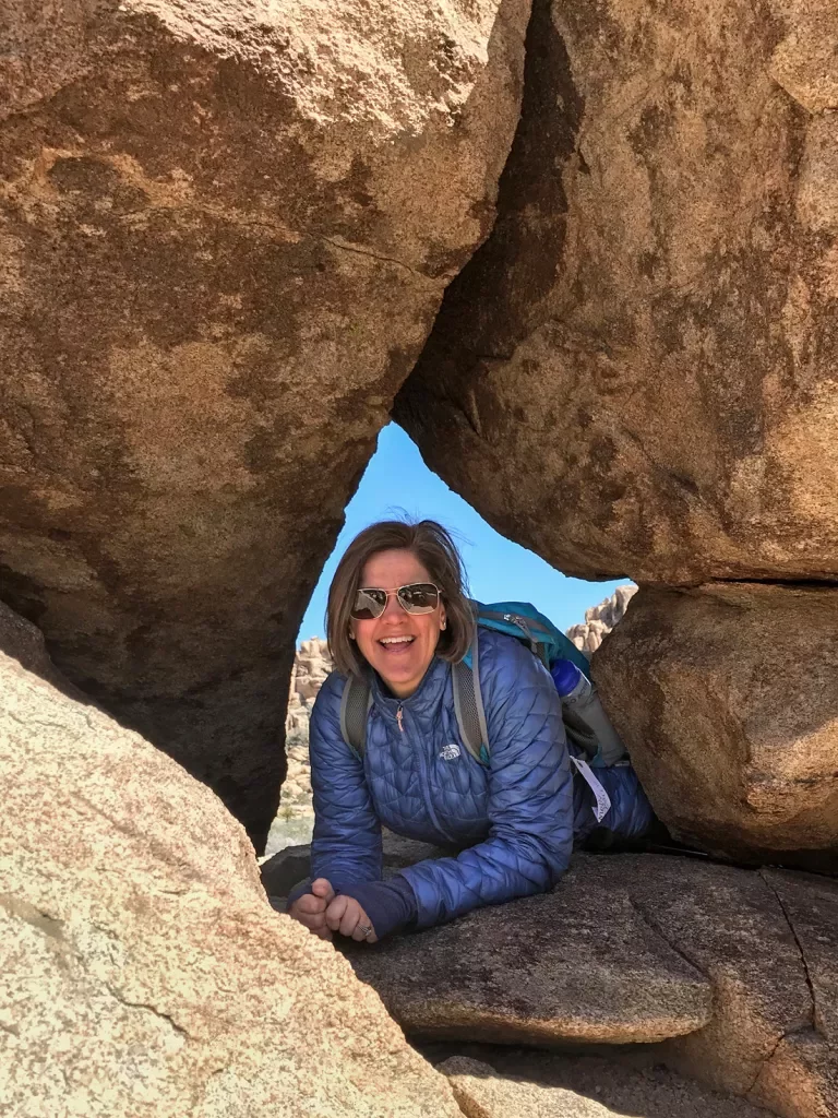 Woman smiling in a rock crevasse 