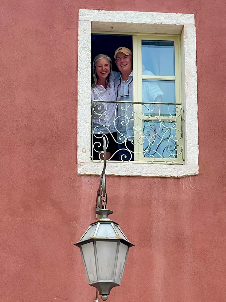 Man and woman smiling through a small window