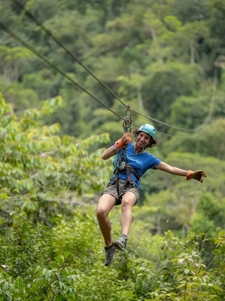 Woman ziplining in the middle of a jungle