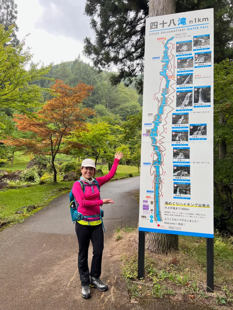 Woman pointing at a Japanese hiking trail map