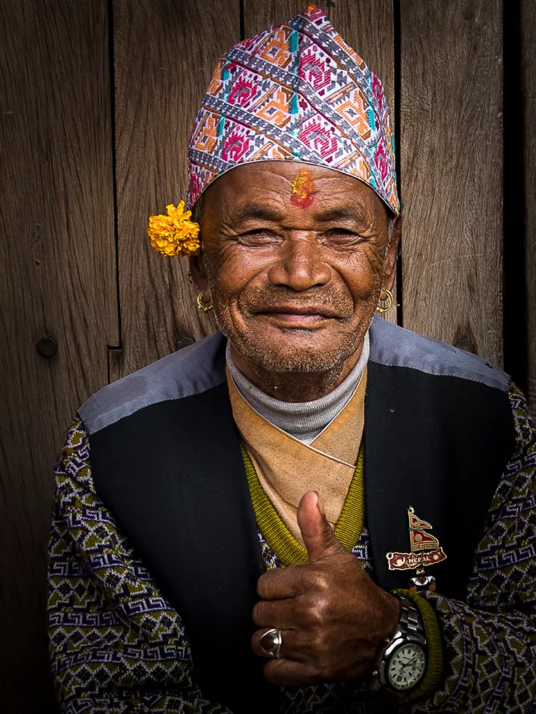 Man with traditional head dress giving a thumbs up