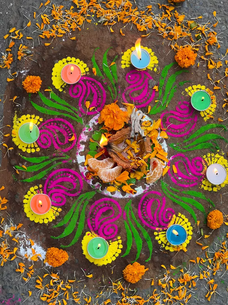 Ritual offerings on a painted ground surrounded by candles